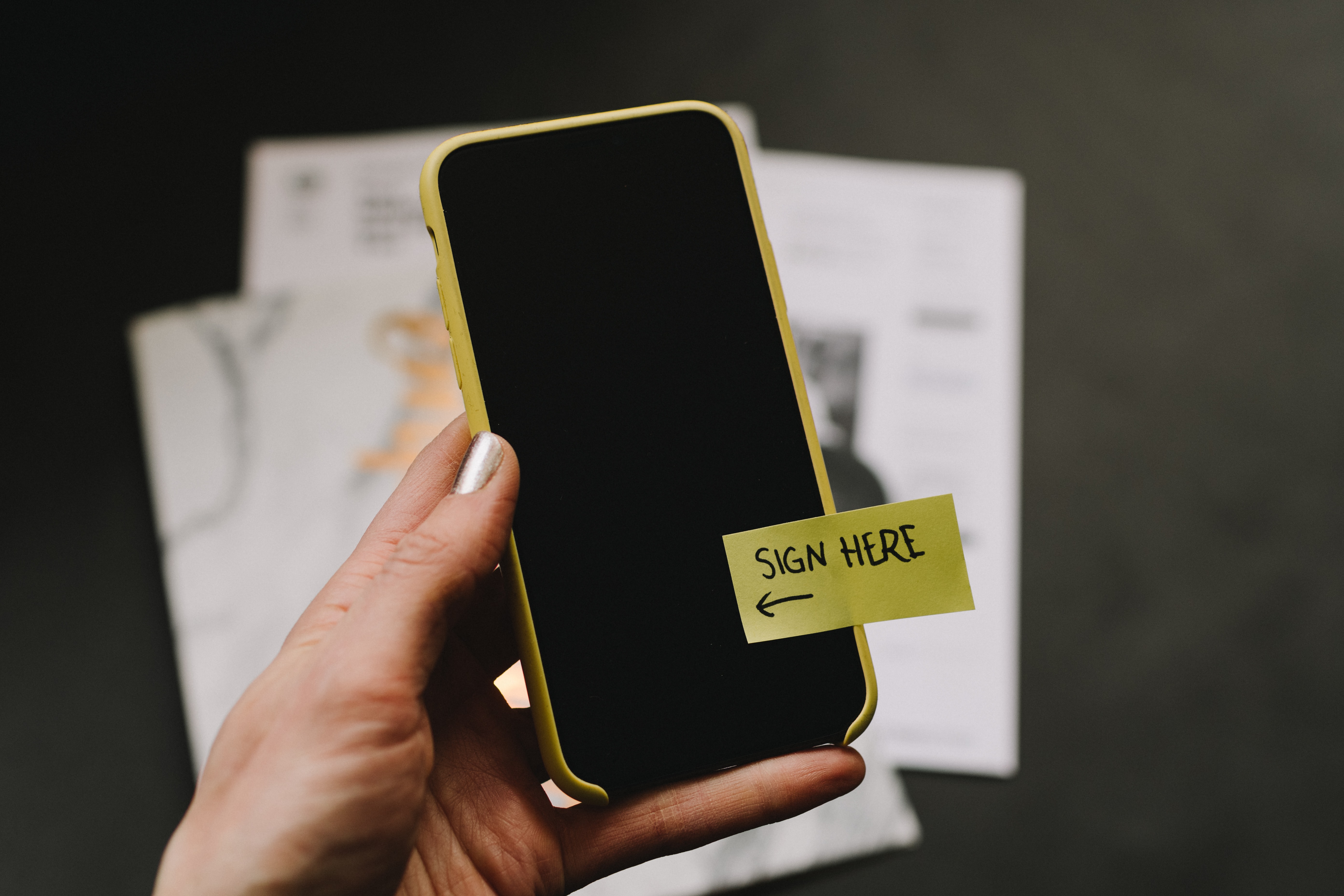Picure of mobile phone and sign here label